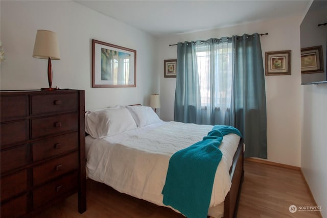 bedroom with hardwood / wood-style floors