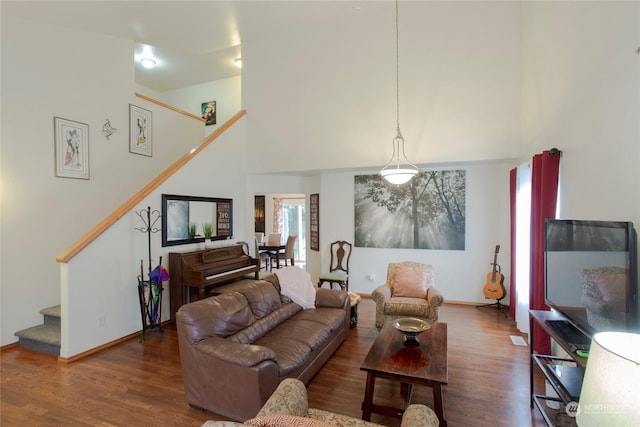 living room featuring hardwood / wood-style flooring and a high ceiling