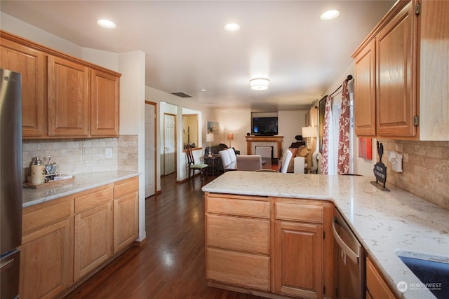 kitchen featuring backsplash, stainless steel appliances, light stone counters, dark hardwood / wood-style flooring, and kitchen peninsula