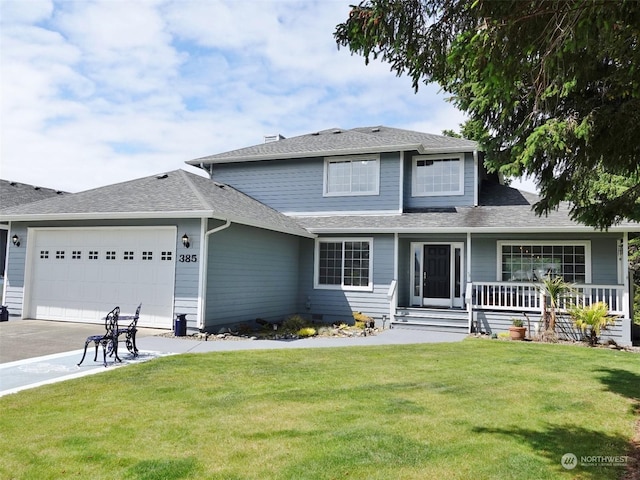 view of property with a garage and a front lawn