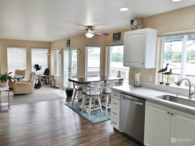 kitchen featuring dishwasher, sink, white cabinets, and a healthy amount of sunlight