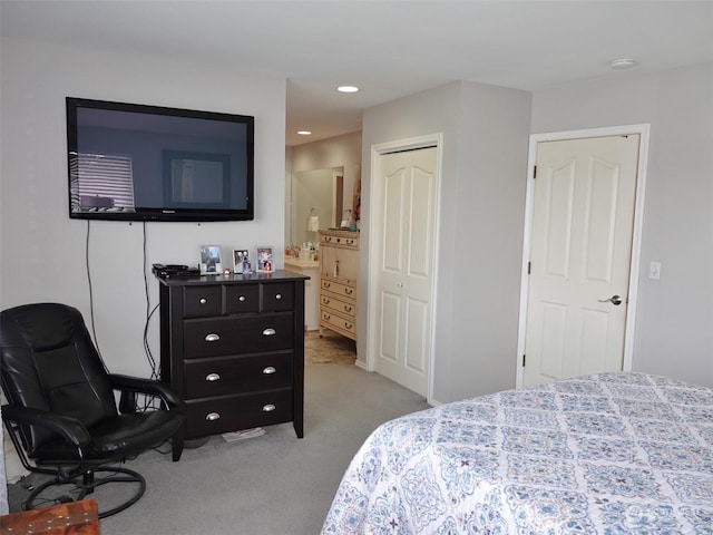 carpeted bedroom with connected bathroom