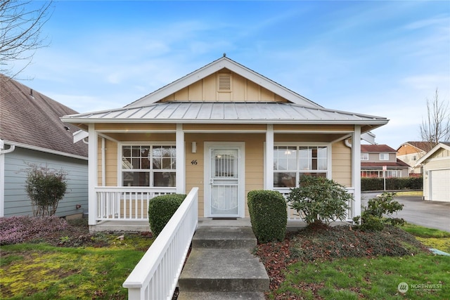 view of front of property with a porch and a garage