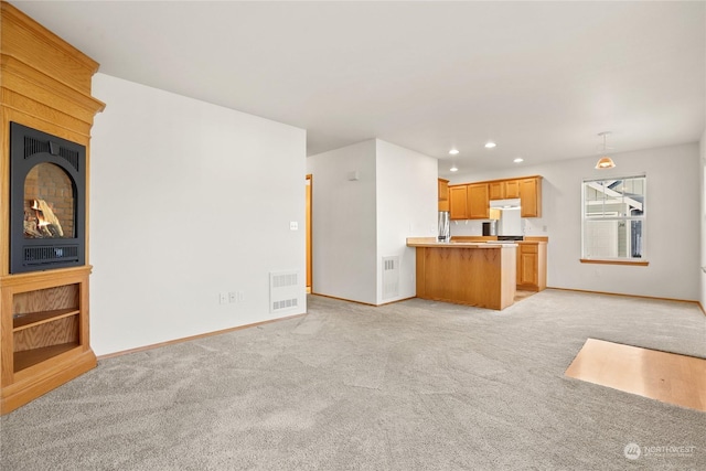 unfurnished living room featuring light colored carpet