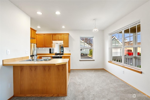 kitchen featuring range with electric stovetop, pendant lighting, stainless steel refrigerator, kitchen peninsula, and light carpet