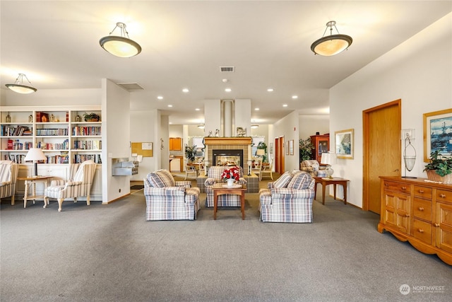 carpeted living room featuring a tile fireplace