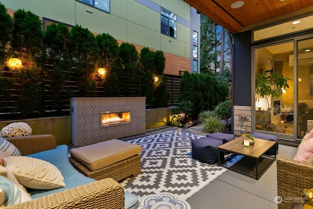 view of patio with an outdoor living space with a fireplace