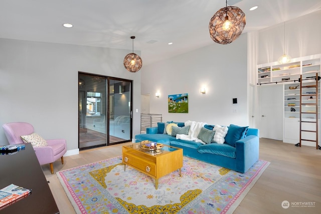 living room featuring vaulted ceiling and light hardwood / wood-style floors