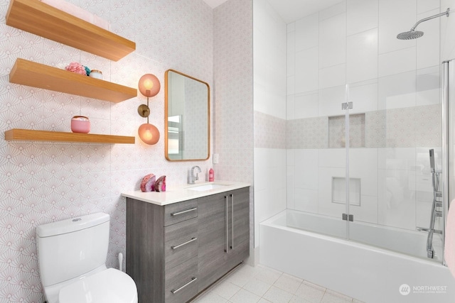 full bathroom with vanity, tile patterned flooring, toilet, and tiled shower / bath