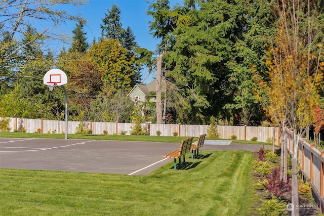 view of sport court with a yard