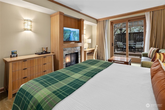 bedroom with carpet floors, access to exterior, a fireplace, and ornamental molding