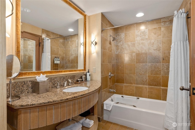 bathroom featuring tile patterned flooring, vanity, tile walls, and shower / bathtub combination with curtain