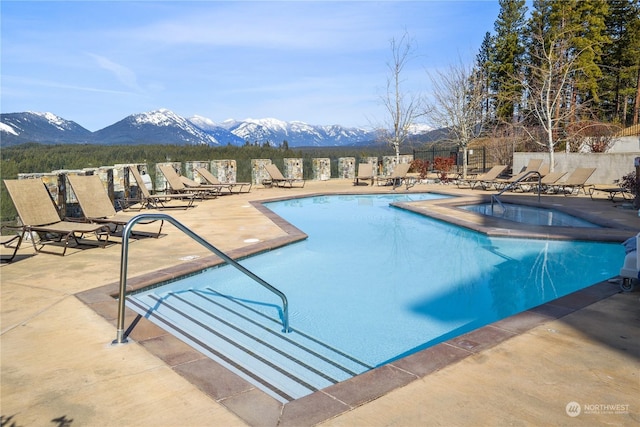 view of pool featuring a mountain view and a patio area