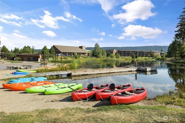 view of home's community featuring a boat dock and a water view