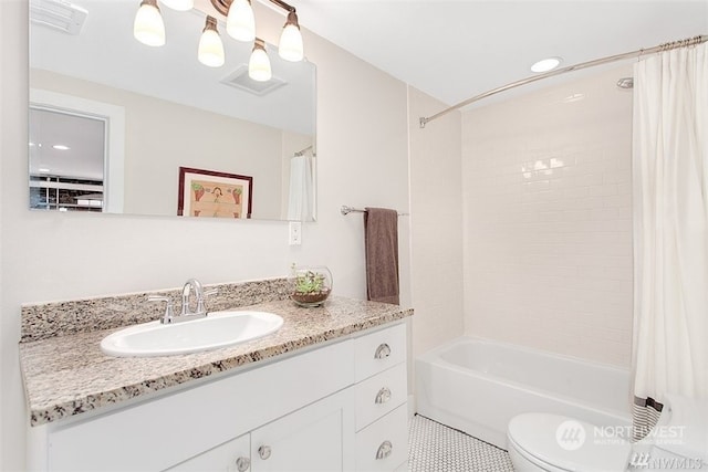 full bathroom featuring vanity, shower / bath combo, and toilet