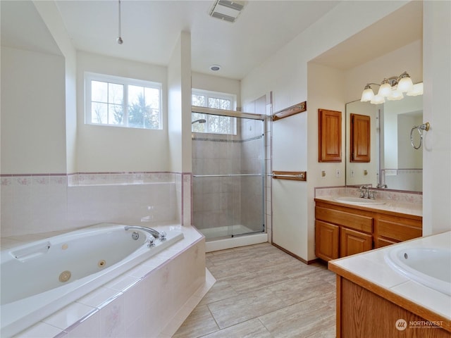 bathroom featuring vanity, shower with separate bathtub, and tile patterned floors