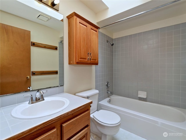 full bathroom with vanity, toilet, and tiled shower / bath combo