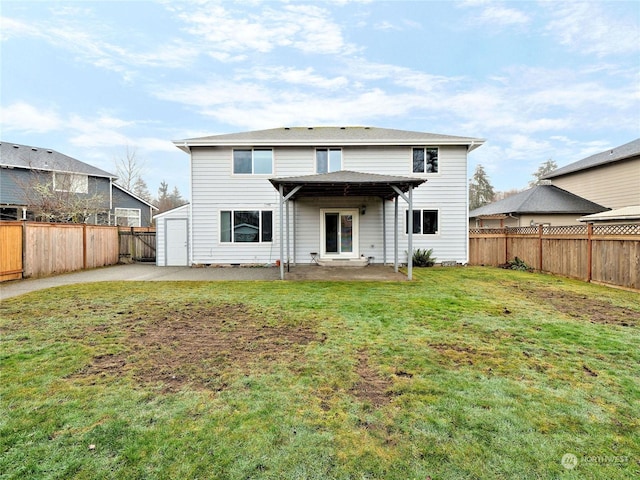 rear view of house featuring a yard and a patio