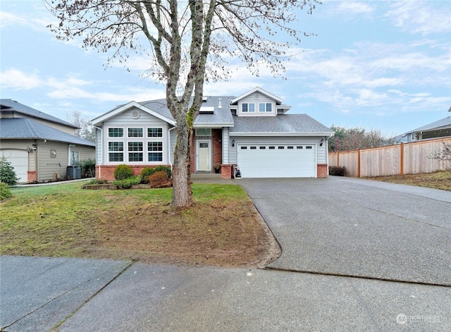 view of front of house with a garage, central AC, and a front yard