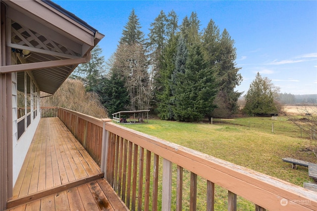 wooden deck with a lawn