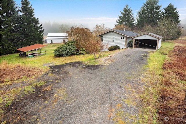 exterior space with a carport and a garage