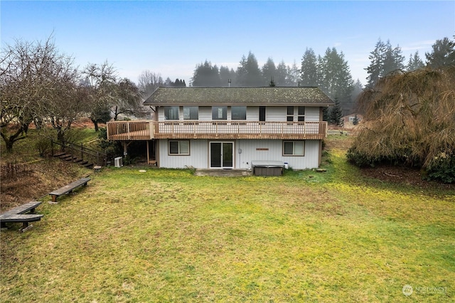 back of house with a wooden deck and a yard