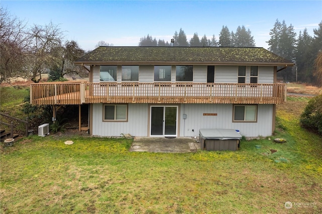 back of house with a wooden deck, a yard, a patio area, and a hot tub