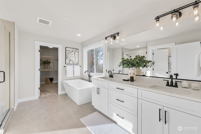 bathroom featuring vanity, independent shower and bath, and tile patterned flooring