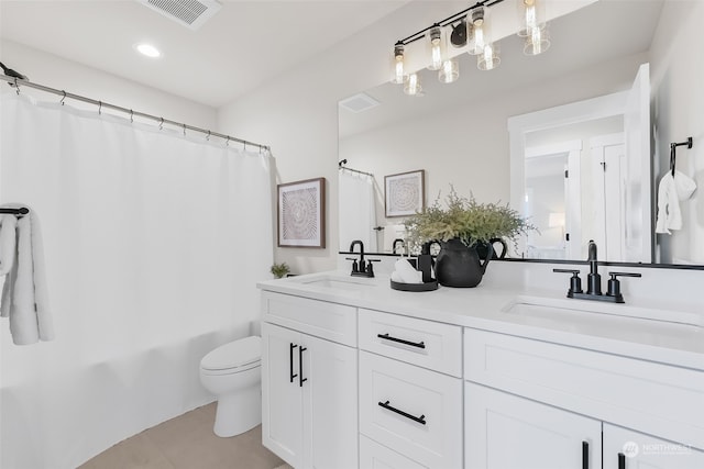 full bathroom with tile patterned flooring, vanity, shower / tub combo, and toilet