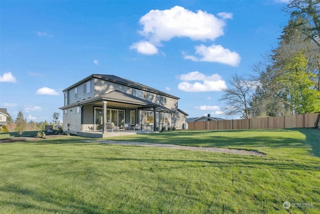 rear view of property with a patio and a lawn