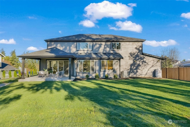 rear view of house with a yard and a patio