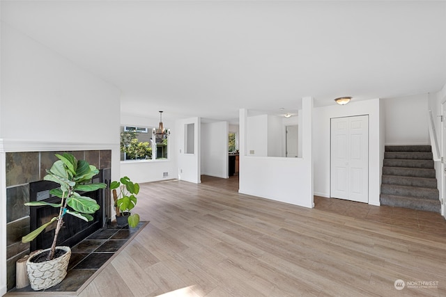 living room featuring wood-type flooring and a chandelier