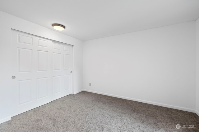 unfurnished bedroom featuring a closet and carpet