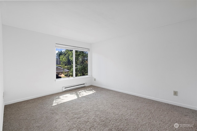 carpeted spare room with a baseboard radiator