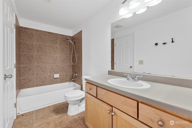 full bathroom with vanity, toilet, and tiled shower / bath