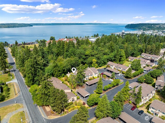 birds eye view of property with a water view