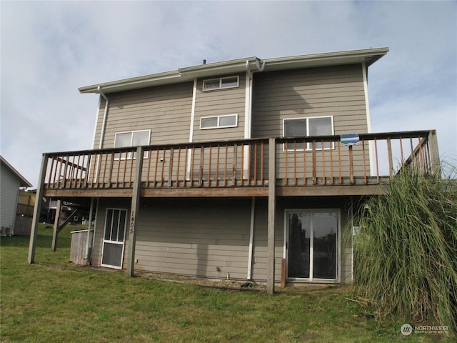 rear view of property with a lawn and a deck