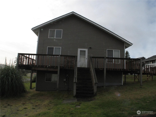 back of house featuring a wooden deck and a yard