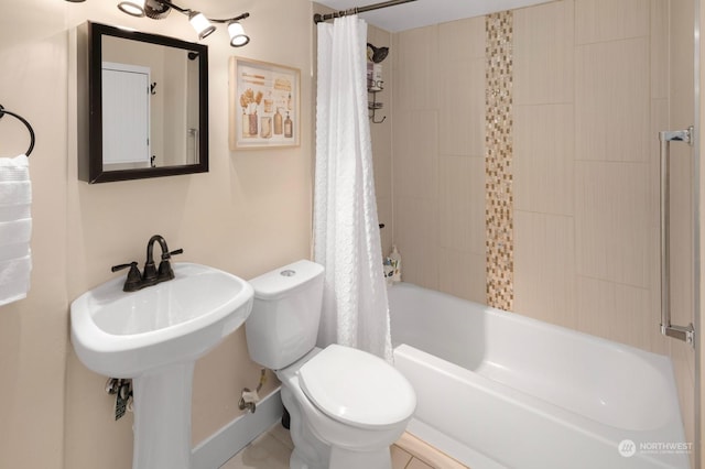 bathroom with shower / tub combo and toilet