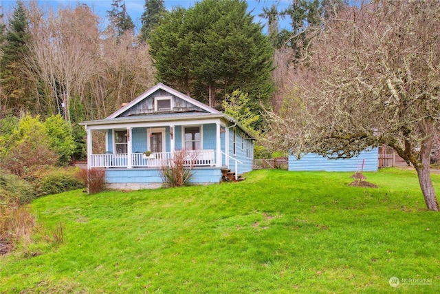 view of front of house featuring a front yard and covered porch