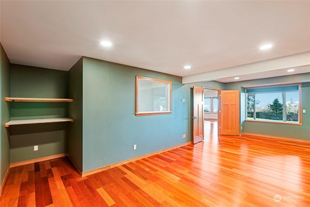 unfurnished living room with wood-type flooring