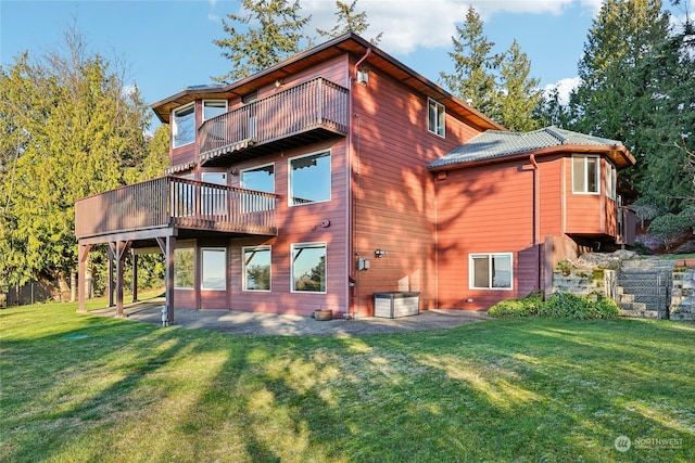 rear view of property featuring a yard and a patio