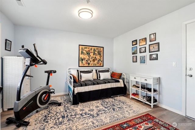 bedroom with hardwood / wood-style flooring