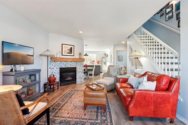 living room featuring a fireplace and dark hardwood / wood-style floors