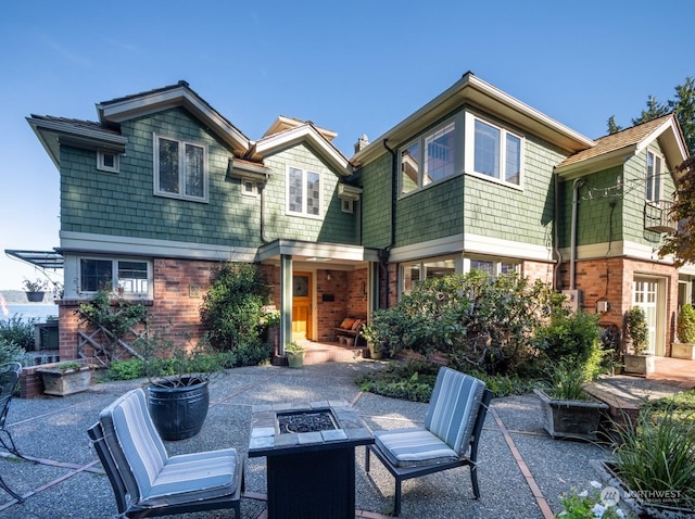 back of house with a patio and a fire pit