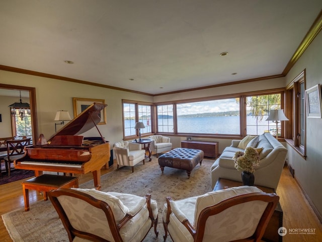 living room with crown molding, a water view, and light hardwood / wood-style floors