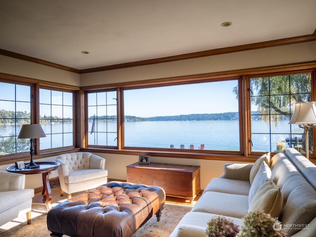 living room with crown molding, light wood-type flooring, and a water view