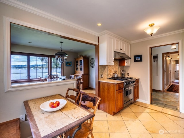 kitchen with white cabinetry, high end stainless steel range, hanging light fixtures, and light tile patterned floors