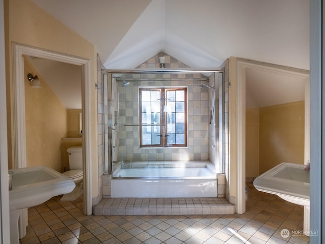 bathroom featuring vaulted ceiling, tile patterned floors, toilet, and separate shower and tub