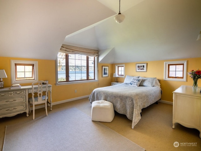 carpeted bedroom featuring lofted ceiling